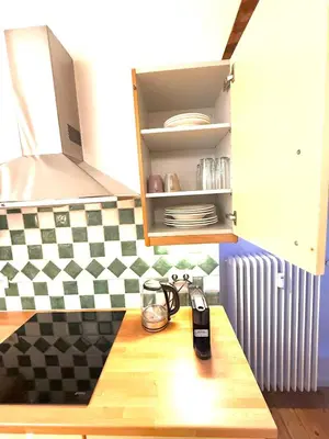 a kitchen with a counter top with a table with a phone at EU District Loft in Brussels