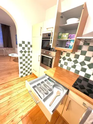 a kitchen with an open drawer in the floor at EU District Loft in Brussels