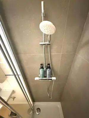a bathroom with a shower with two bottles on a shelf at EU District Loft in Brussels