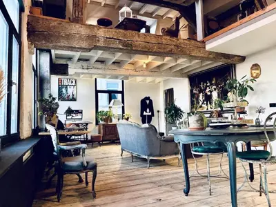 a living room with a table and chairs at The Mystical Suite in Antwerp