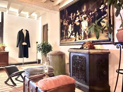 a room with a suit and a painting on the wall at The Mystical Suite in Antwerp