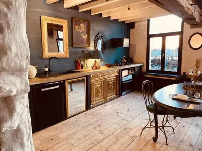 a kitchen with a table and a table and a dining room at The Mystical Suite in Antwerp