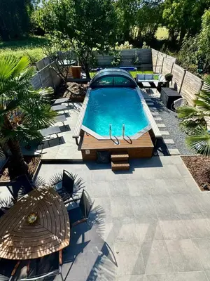 a swimming pool with a car parked next to it at B&B Wellness Garden in Herzele