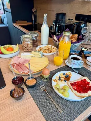 a table topped with plates of food and drinks at B&B Wellness Garden in Herzele