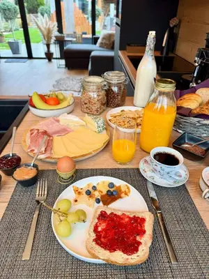 a table with a plate of food with fruit on it at B&B Wellness Garden in Herzele
