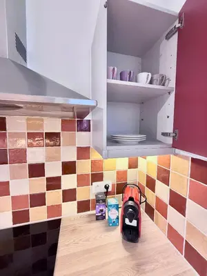 a kitchen with a vacuum cleaner on a kitchen counter at Schuman Square Residence in Brussels
