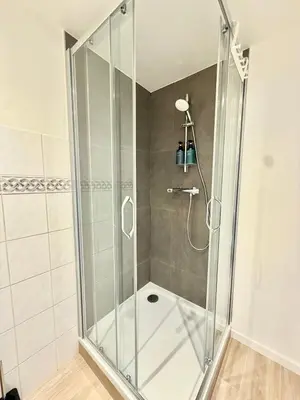 a shower with a glass door in a bathroom at Schuman Square Residence in Brussels
