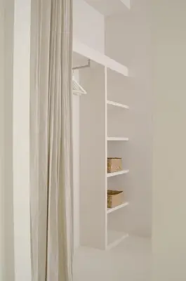 a curtain in front of a window with a mirror at Luxurious 1BR Apartment with Parking in Antwerp