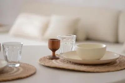 a table with a plate and two glasses on it at Luxurious 1BR Apartment with Parking in Antwerp