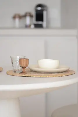 a plate and bowls on a wooden tray on a counter at Luxurious 1BR Apartment with Parking in Antwerp