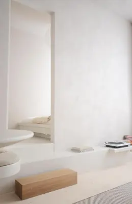 a white room with two beds and a wooden table at Luxurious 1BR Apartment with Parking in Antwerp