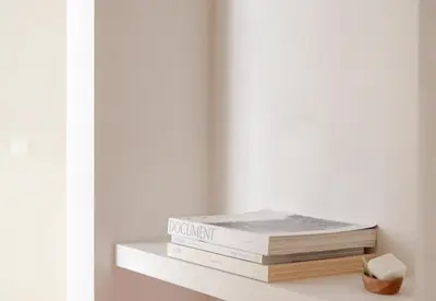 a stack of books sitting on a shelf at Luxurious 1BR Apartment with Parking in Antwerp