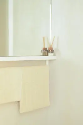 a white shelf with towels on it in a bathroom at Luxurious 1BR Apartment with Parking in Antwerp