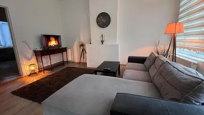 a living room with a couch and a tv at Appartement Bruxelles 1 in Brussels