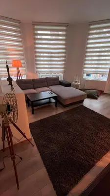 a living room with a couch and a table at Appartement Bruxelles 1 in Brussels