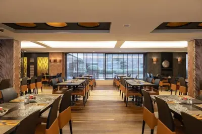 a dining room with long tables and chairs at Sunset Paradise Tomorrowland hotel and transport at Hyllit Antwerp in Antwerp