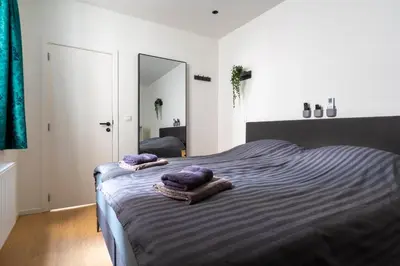 a bedroom with a bed with purple towels on it at heartatd'Anvers Original in Antwerp