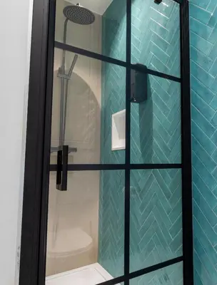 a bathroom with a shower with a glass door at heartatd'Anvers Original in Antwerp