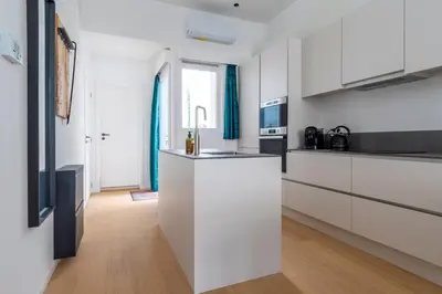 a kitchen with white cabinets and a counter top at heartatd'Anvers Original in Antwerp