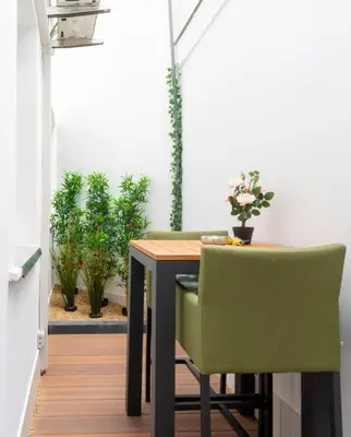 a dining room table with green chairs and plants at heartatd'Anvers Original in Antwerp