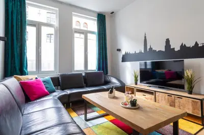 a living room with a leather couch and a coffee table at heartatd'Anvers Original in Antwerp
