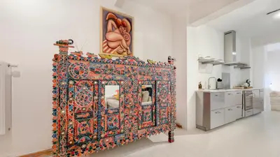 a room with a bed with an oriental rug at Cosy loft near City Centre, Terra CasaMia in Antwerp