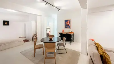 a white living room with a table and chairs at Cosy loft near City Centre, Terra CasaMia in Antwerp