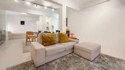 a living room with a white couch and a table at Cosy loft near City Centre, Terra CasaMia in Antwerp