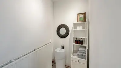a bathroom with a toilet and a shelf at Cosy loft near City Centre, Terra CasaMia in Antwerp