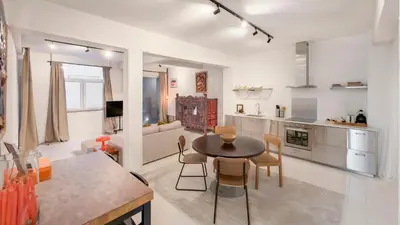a kitchen and living room with a table and chairs at Cosy loft near City Centre, Terra CasaMia in Antwerp