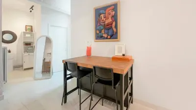 a dining room with a table and a painting on the wall at Cosy loft near City Centre, Terra CasaMia in Antwerp