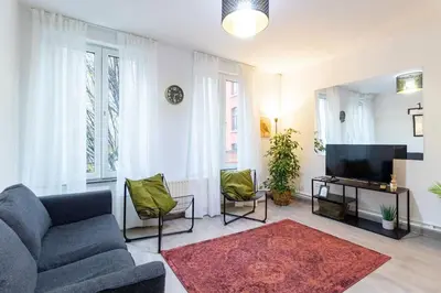 a living room with a couch and a tv at Apartment over two floors for 5 guests near Midi & Grand Place in Brussels