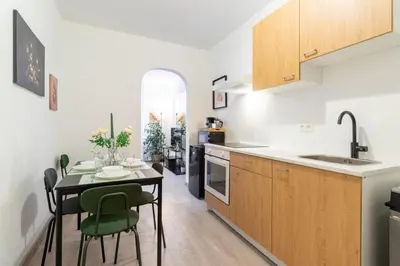 a kitchen and dining room with a table and chairs at Apartment over two floors for 5 guests near Midi & Grand Place in Brussels