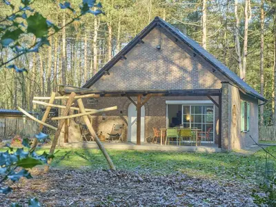 a small cottage in the woods with a patio at Lierelodge in Oud-Turnhout