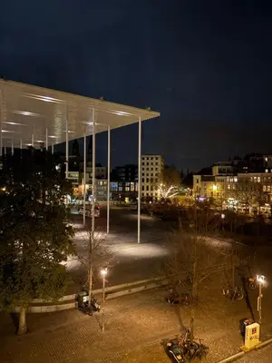 a parking lot with a building in a city at night at Design studio met hotel vibe in Antwerp