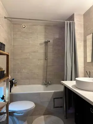 a bathroom with a tub and a toilet and a sink at Design studio met hotel vibe in Antwerp