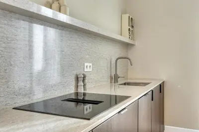 a kitchen with a sink and a counter top at Spacious 3-bedroom apartment with terrace Zurenborg in Antwerp