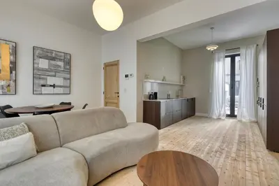 a living room with a couch and a table at Spacious 3-bedroom apartment with terrace Zurenborg in Antwerp