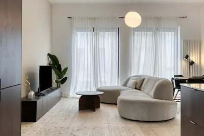 a living room with a couch and a tv at Spacious 3-bedroom apartment with terrace Zurenborg in Antwerp