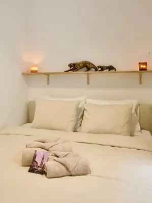 a bedroom with two beds with towels on them at Hip apartment between South & Historic Antwerp in Antwerp