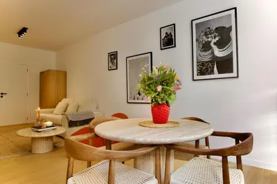 a living room with a table and chairs at Hip apartment between South & Historic Antwerp in Antwerp