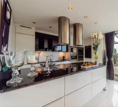 a kitchen with two wine glasses on a counter at Vaste et somptueux appartement à Bruxelles in Brussels