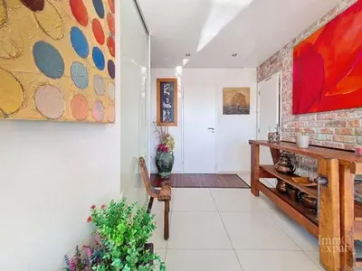 a living room with a painting on the wall at Vaste et somptueux appartement à Bruxelles in Brussels