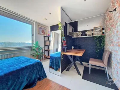 a bedroom with a bed and a table and a desk at Vaste et somptueux appartement à Bruxelles in Brussels