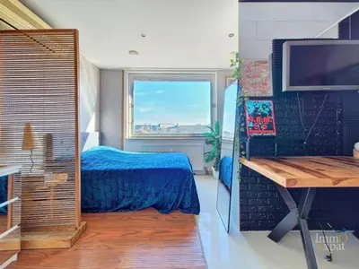 a bedroom with a blue bed and a window at Vaste et somptueux appartement à Bruxelles in Brussels