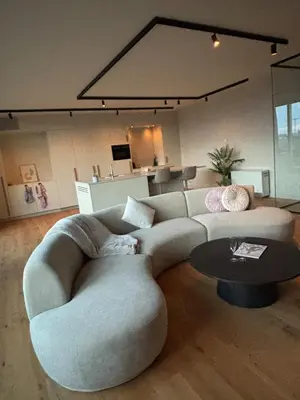 a living room with a couch and a table at Spacious luxurious 1 bedroom stay in the city center in Antwerp