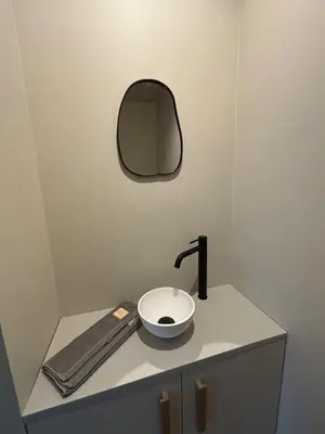a bathroom with a sink and a mirror on a counter at Spacious luxurious 1 bedroom stay in the city center in Antwerp