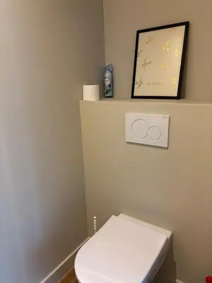 a bathroom with a white toilet and a picture at Spacious luxurious 1 bedroom stay in the city center in Antwerp