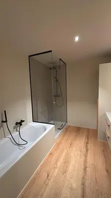 a bathroom with a tub and a glass shower at Spacious luxurious 1 bedroom stay in the city center in Antwerp