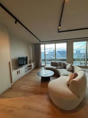 a living room with a couch and a table at Spacious luxurious 1 bedroom stay in the city center in Antwerp